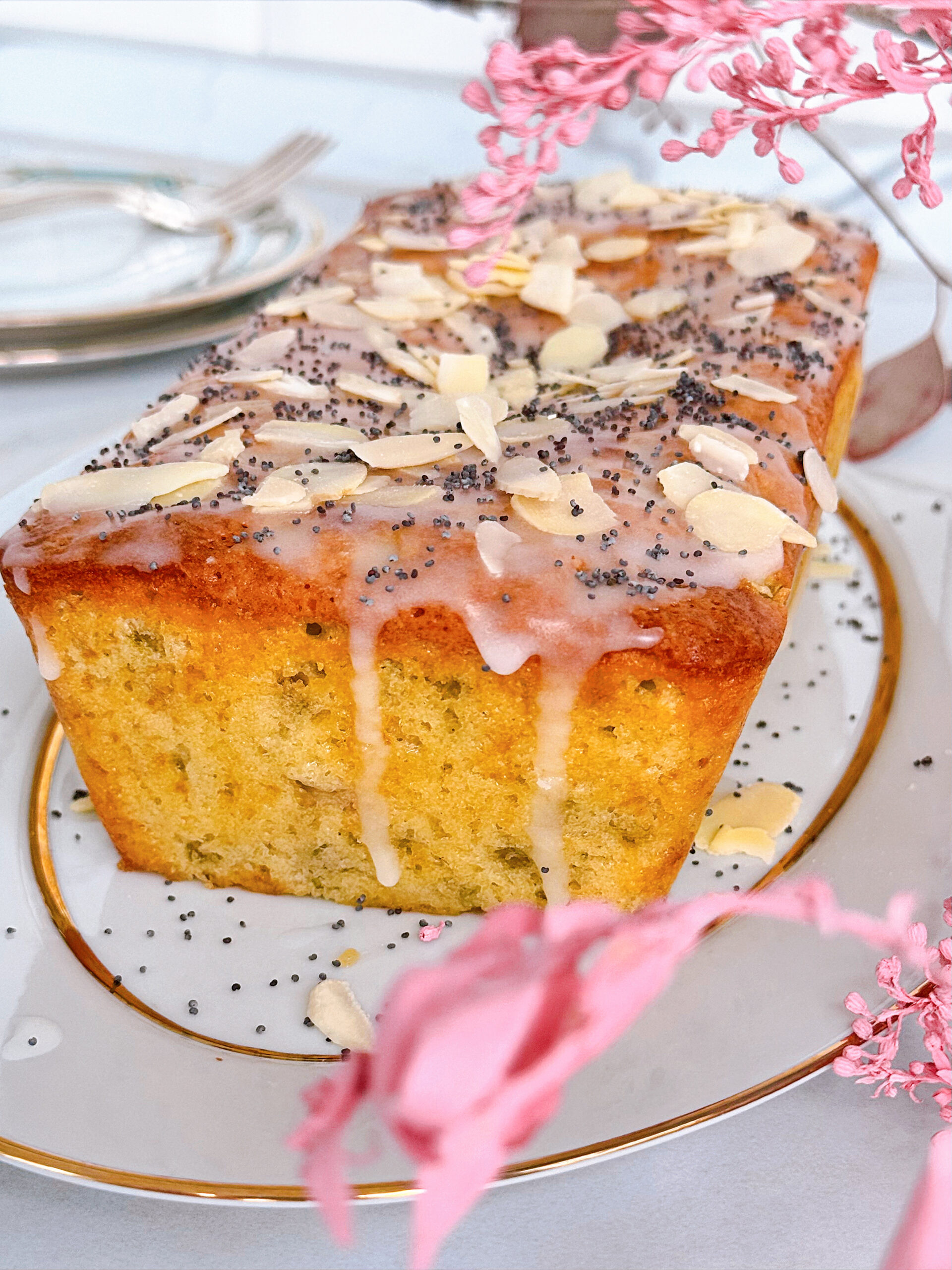 солодкий кекс з ревенем прикрашений мигдалевими пластівцями та насінням маку