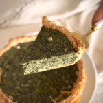 Золотистий кіш з зеленню на фоні лляної серветки, текстура рикоти зі шпинатом